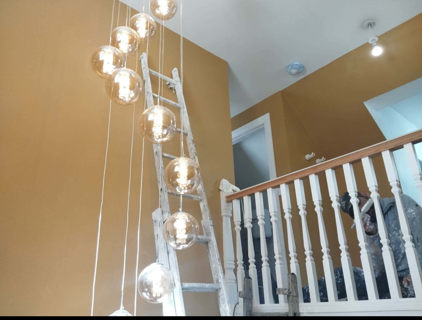 Job C view 2 after: ochre stairwell with pendant lights