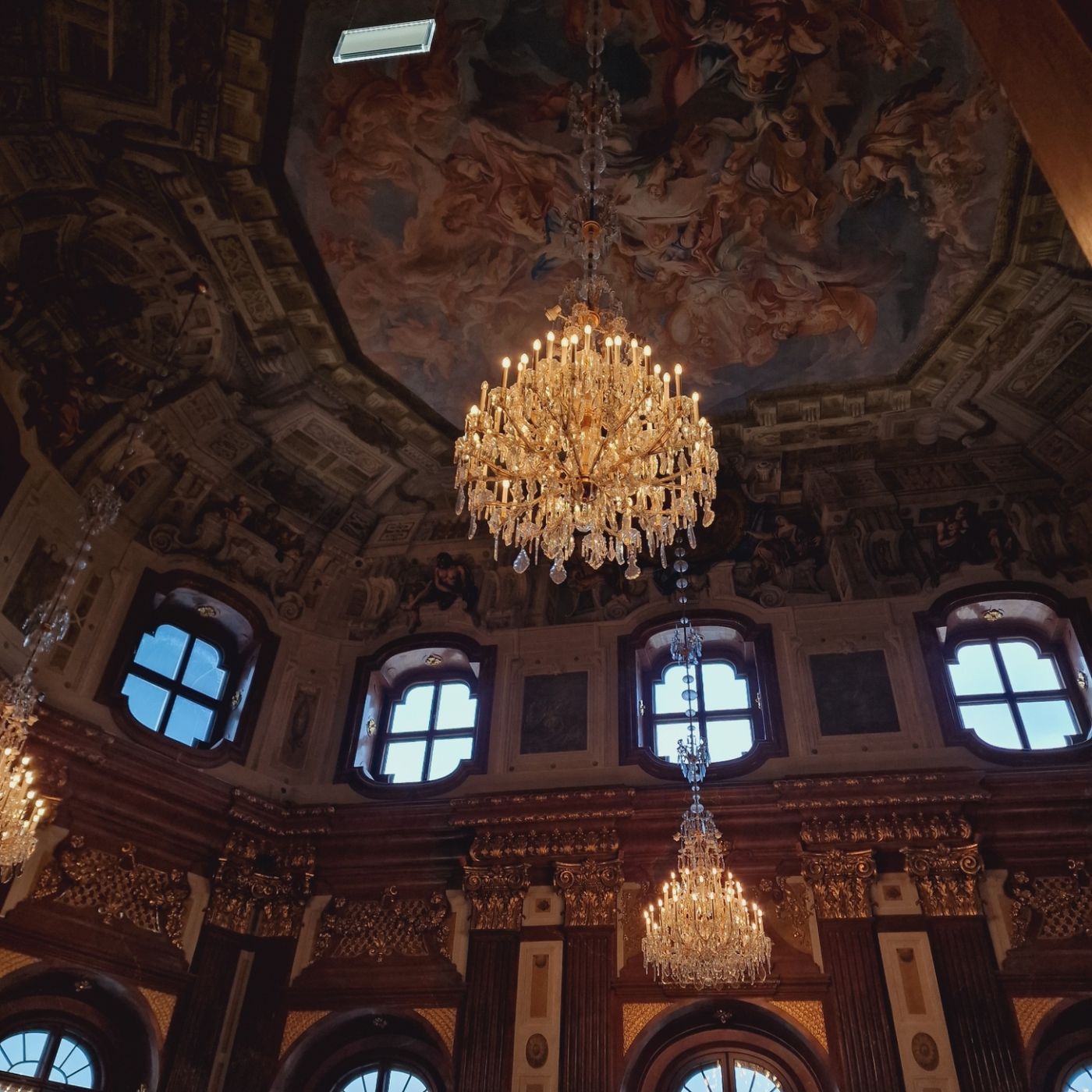 Crystal chandelier under a painted ceiling