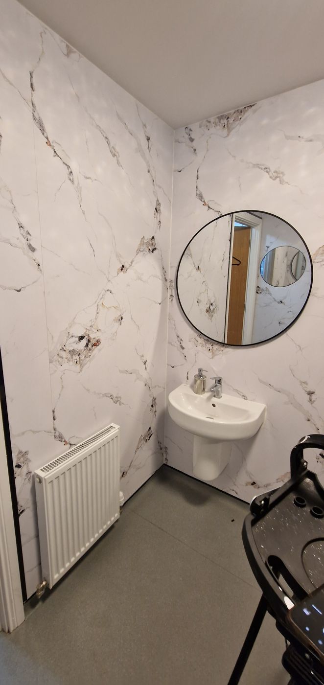 Job E wall 2 after: marble panels around the radiator and basin