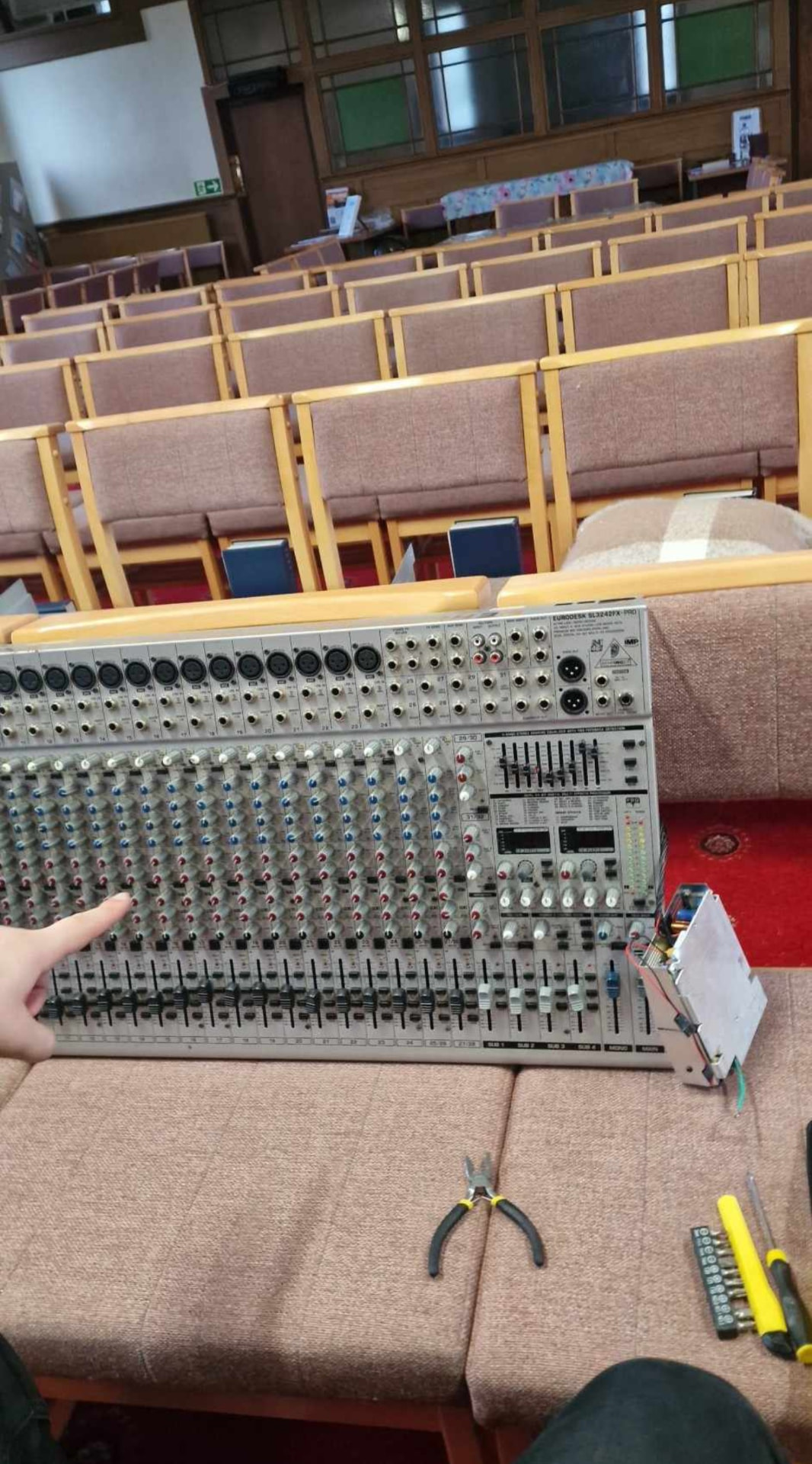 Large analogue mixing desk on the bench with tools