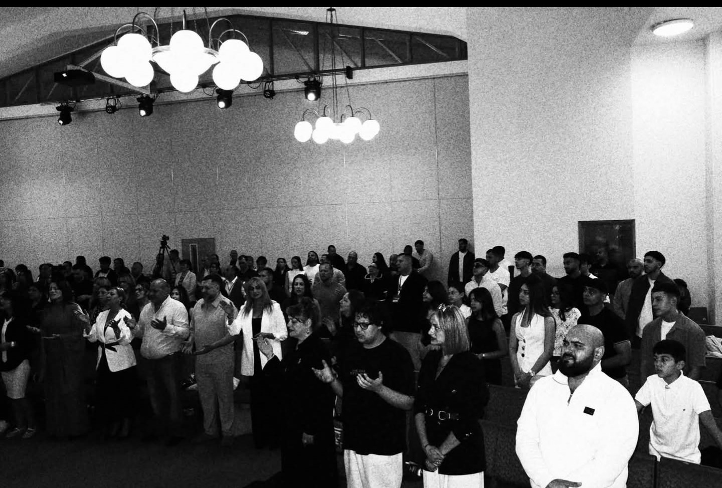 Black and white photo of a packed conference hall