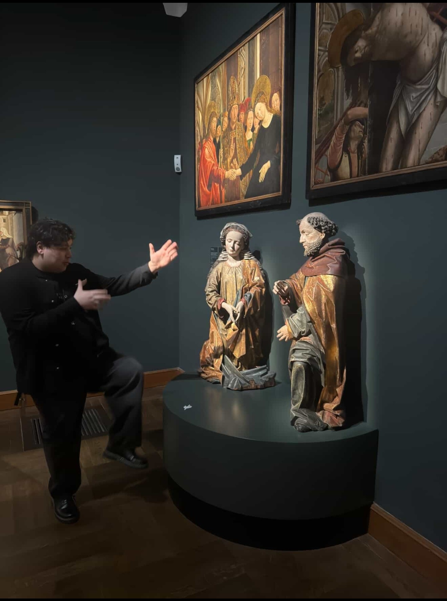 Samuels pretending to fight a statue in a museum
