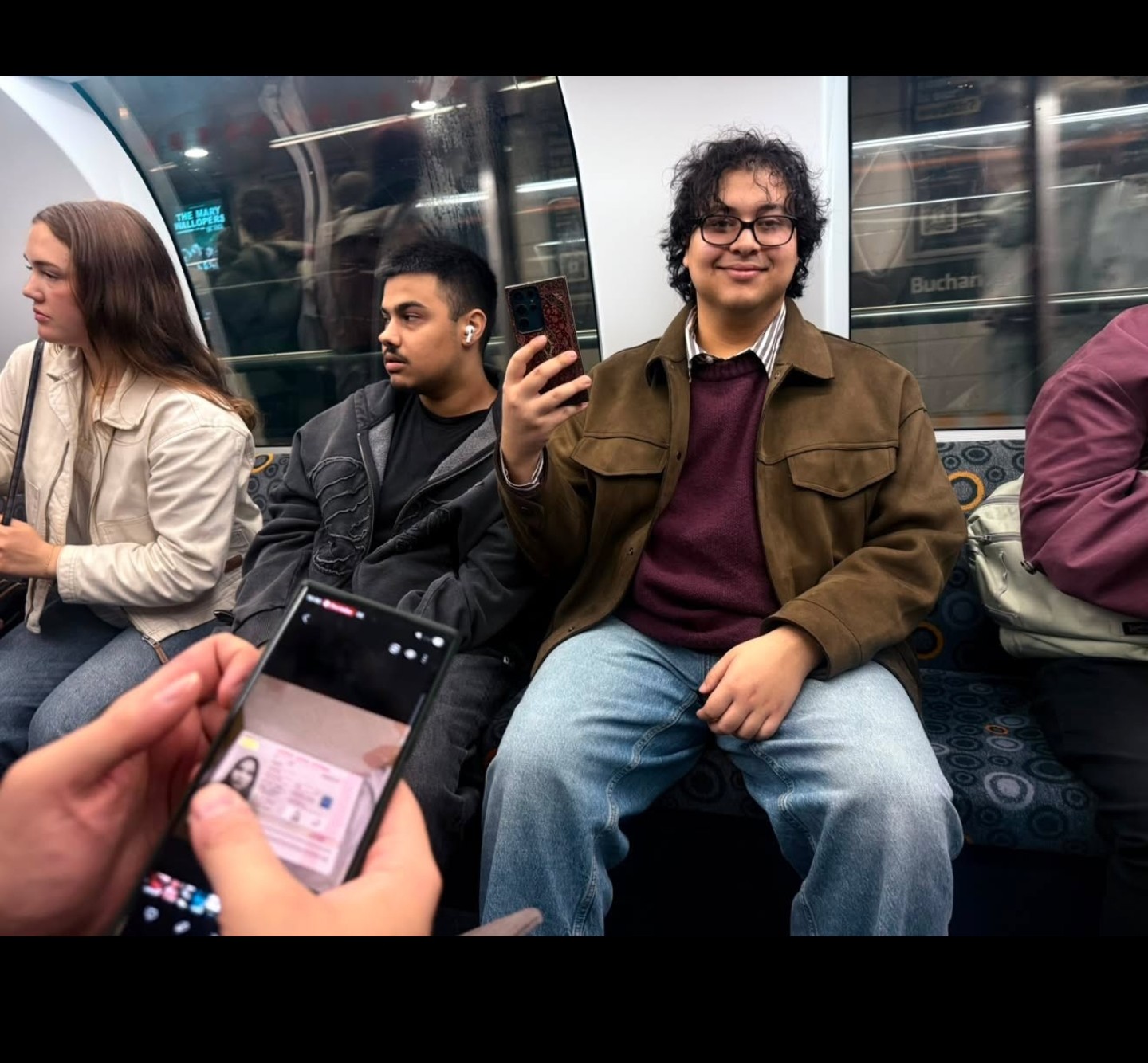 Samuels smiling on a train