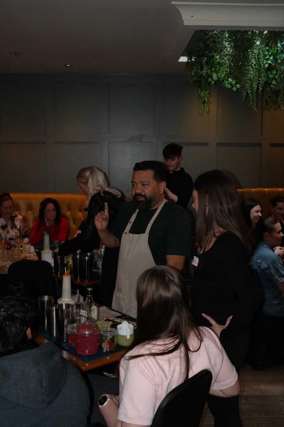 Bartender in an apron leading the cocktail masterclass