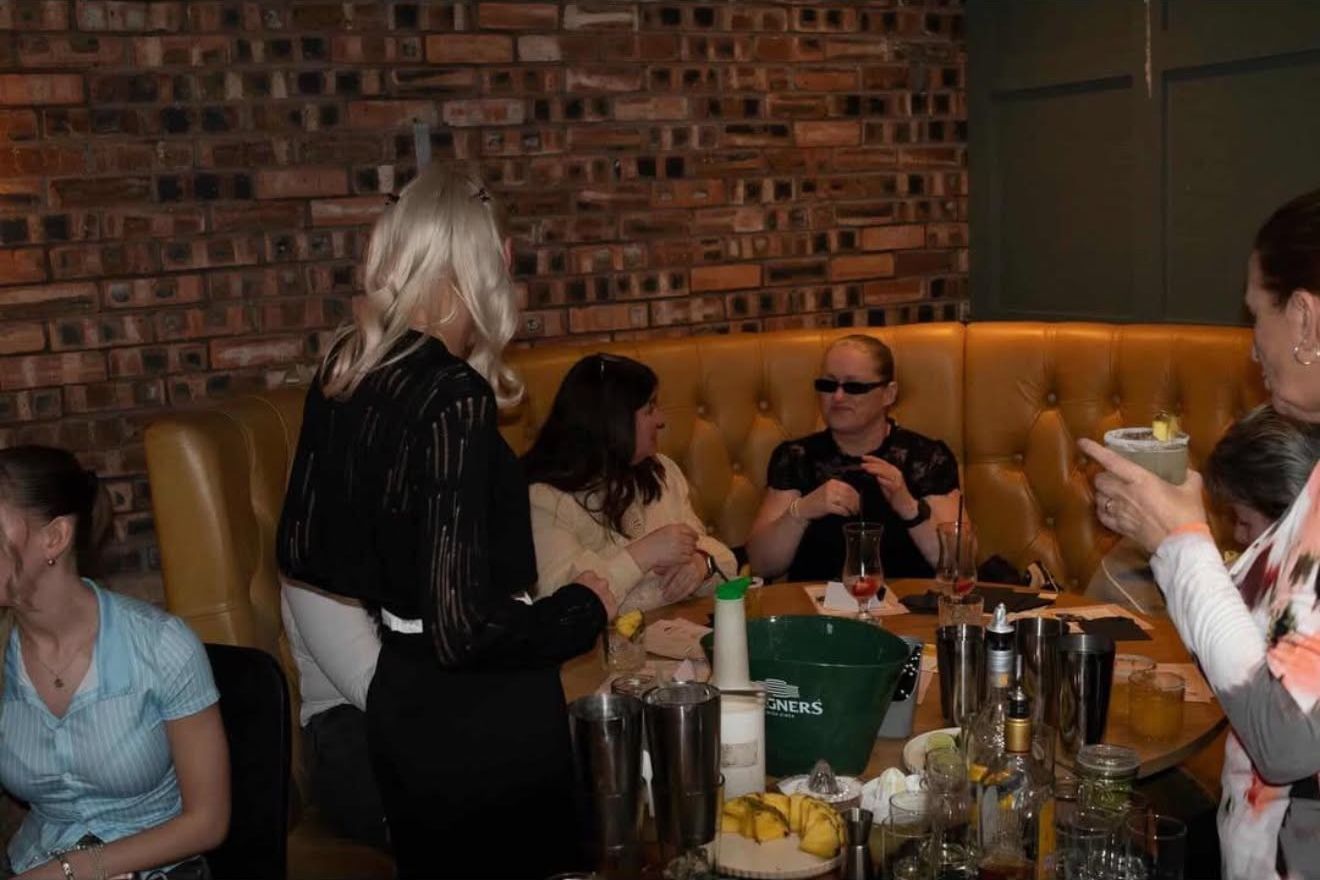 Guests in a booth making cocktails
